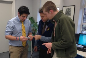 Sami Petros, Mr. Hess, and Brian Sovacool look at Sami's prototype for the "Fun Box, powered by Raspberry Pi"